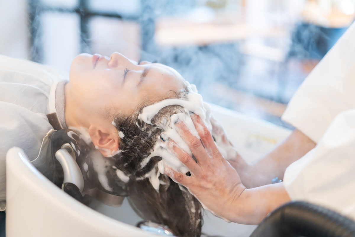 Woman receiving a scalp massage in Louisville, KY